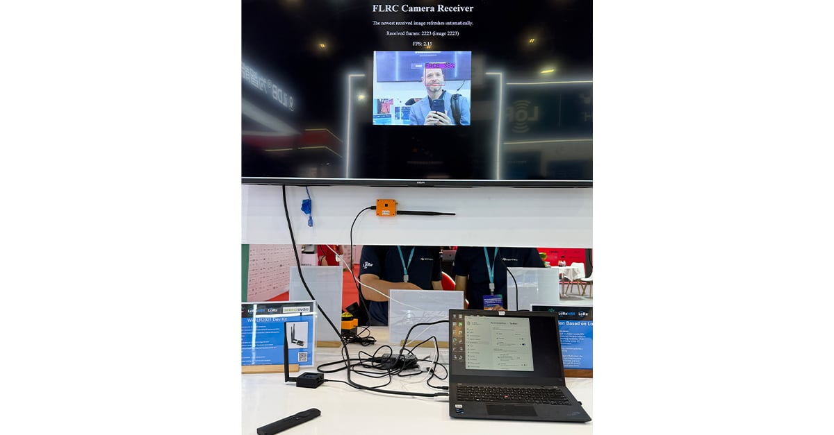 FLRC Camera Receiver screen showing a live long-range video transmission test at IOTE Shenzhen 2026
